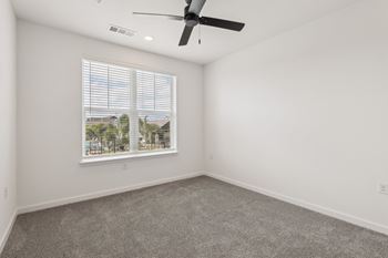 A room with a ceiling fan and a window with blinds. at The Junction at Rockledge Apartments, Rockledge 32955